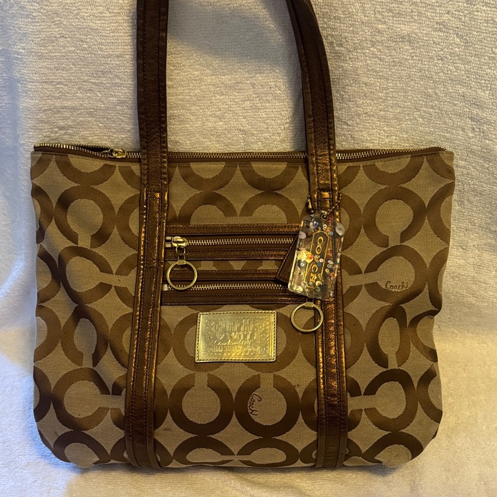COACH Poppy Op Art Glam Bag in Brown with metallic gold tag and metallic trim